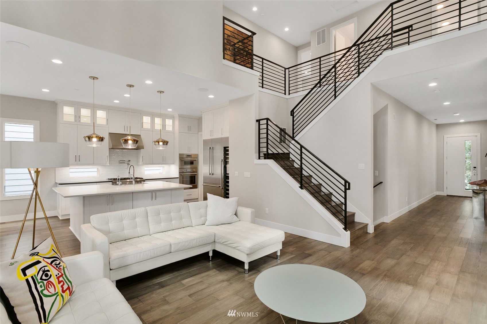 21899 Southeast 5th Place Sammamish, WA 98074 - Photo 4 of 35 a living room with furniture and a dining table with wooden floor