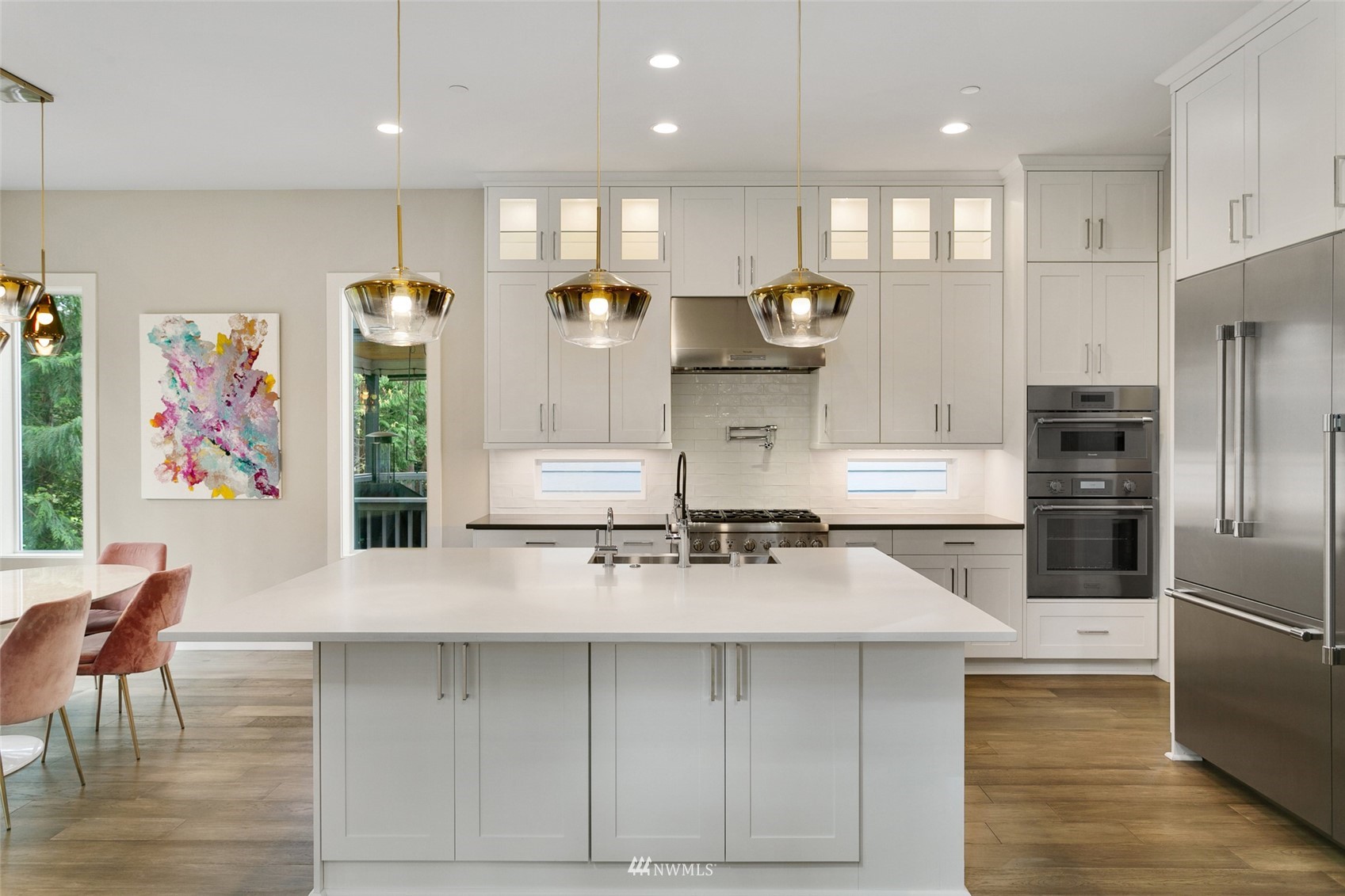 21899 Southeast 5th Place Sammamish, WA 98074 - Photo 5 of 35 a kitchen with stainless steel appliances a sink a stove a refrigerator and cabinets