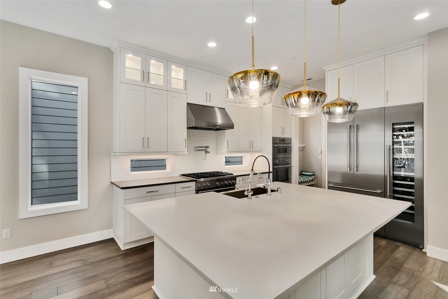 21899 Southeast 5th Place Sammamish, WA 98074 - Photo 6 of 35 a kitchen with stainless steel appliances a sink a stove a refrigerator and cabinets