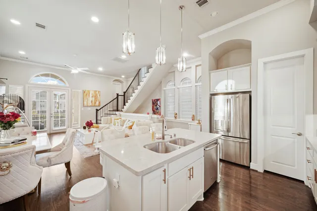 a kitchen with sink refrigerator and fireplace