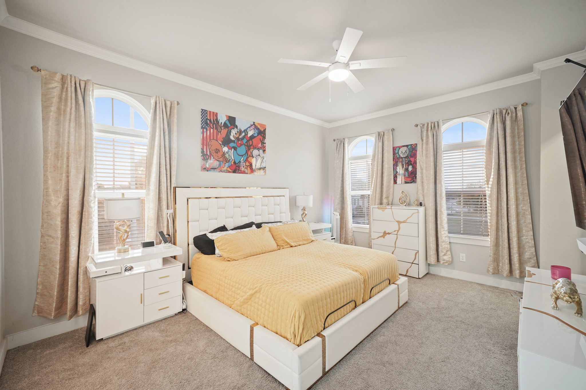 606 North Nagle Street Houston, TX 77003 - Photo 6 of 13 a spacious bedroom with a large bed and a chandelier