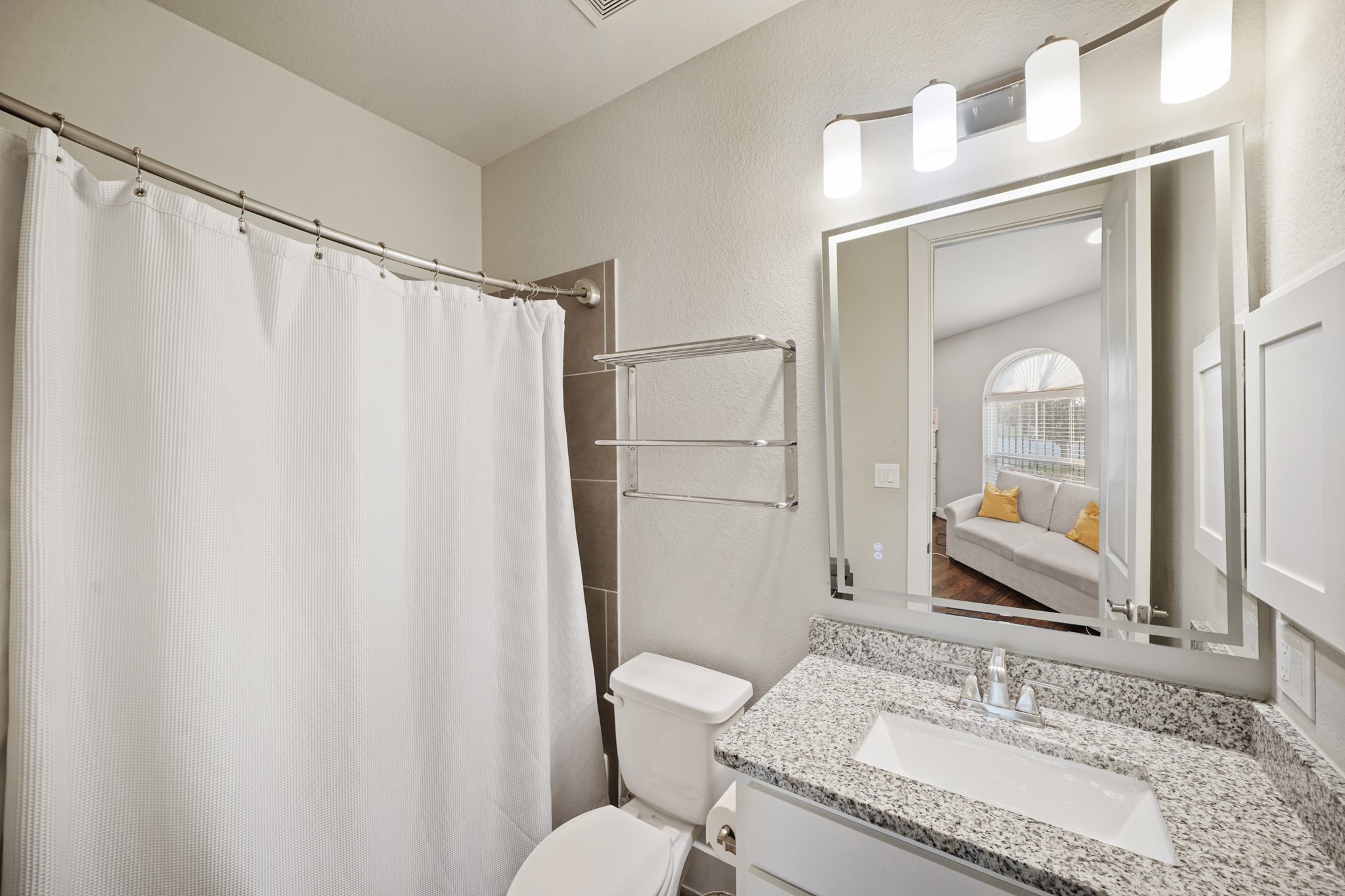 606 North Nagle Street Houston, TX 77003 - Photo 10 of 13 a bathroom with a granite countertop sink and a mirror
