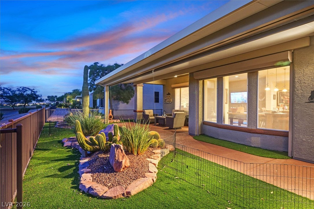 1823 Baton Rouge Street Henderson, NV 89052 - Photo 39 of 60 An inviting covered patio looks out over a manicured lawn with desert landscaping.