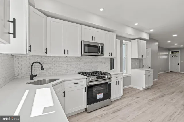 a kitchen with a sink stove and refrigerator