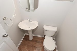 10049 Cummings Street Huntley, IL 60142 - Photo 17 of 30 a bathroom with a toilet sink and a mirror