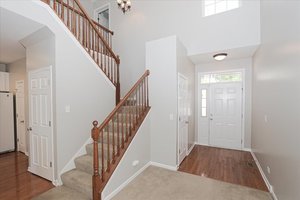 10049 Cummings Street Huntley, IL 60142 - Photo 4 of 30 a view of a hallway with wooden floor and entryway