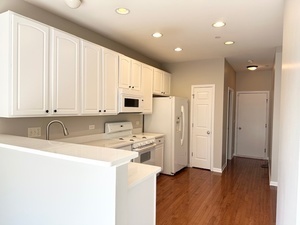 10049 Cummings Street Huntley, IL 60142 - Photo 6 of 30 a kitchen with stainless steel appliances granite countertop a coffee maker a sink a refrigerator and white cabinets with wooden floor