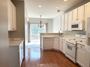 10049 Cummings Street Huntley, IL 60142 - Photo 9 of 30 a kitchen with a white cabinets and wooden floor