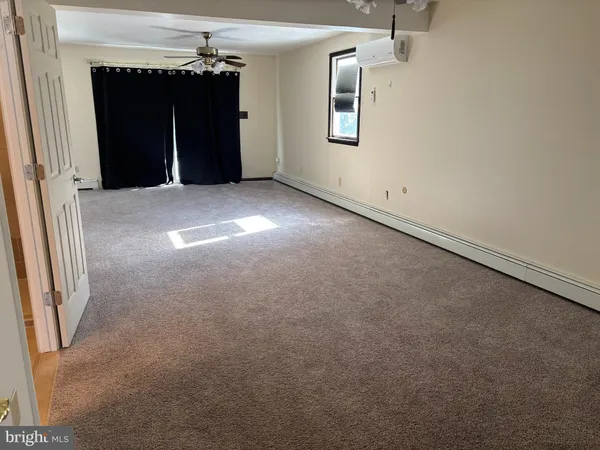 an empty room with windows and closet