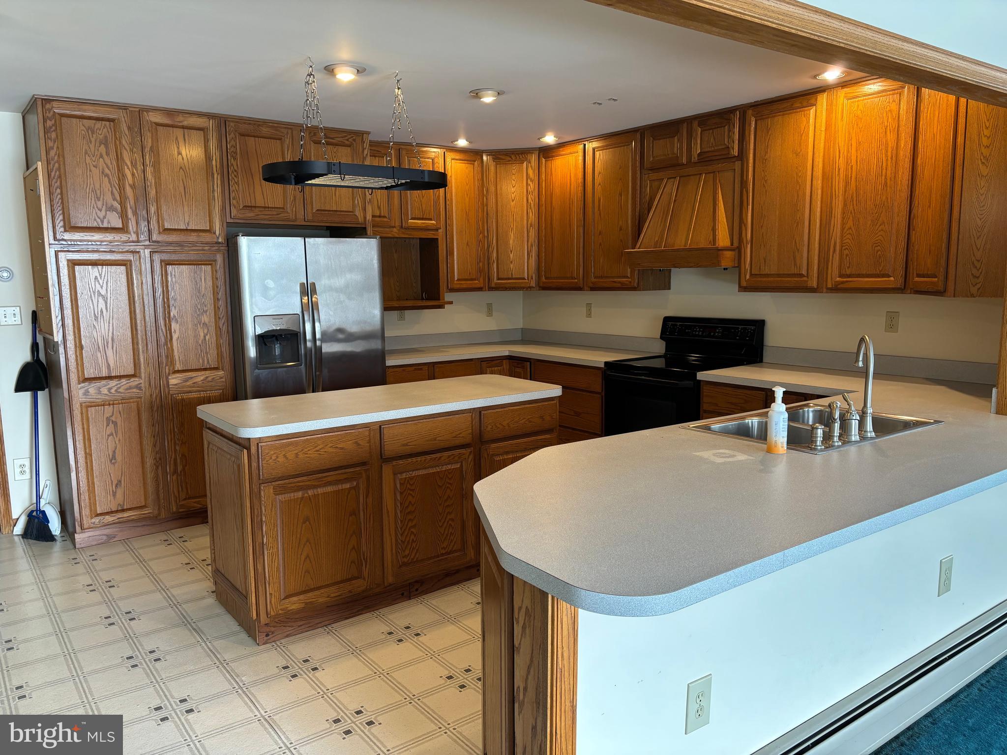 312 North Sandy Hill Road Coatesville, PA 19320 - Photo 7 of 23 a kitchen with stainless steel appliances granite countertop a sink a stove and a refrigerator