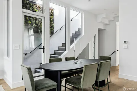 a view of a room with furniture and wooden floor