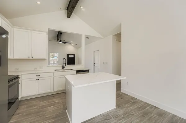 a kitchen with cabinets a sink and appliances