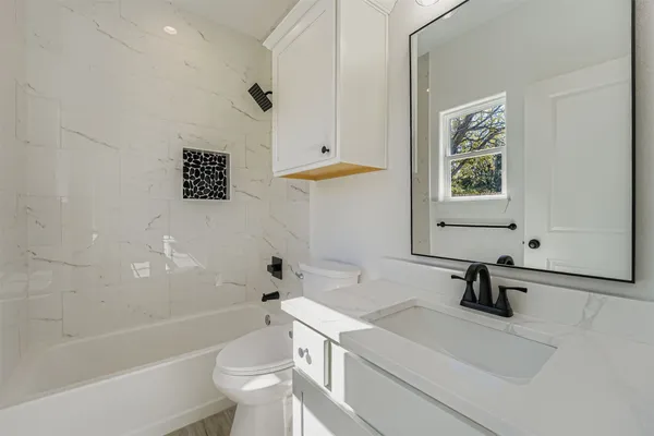 a bathroom with a sink a toilet and a bathtub