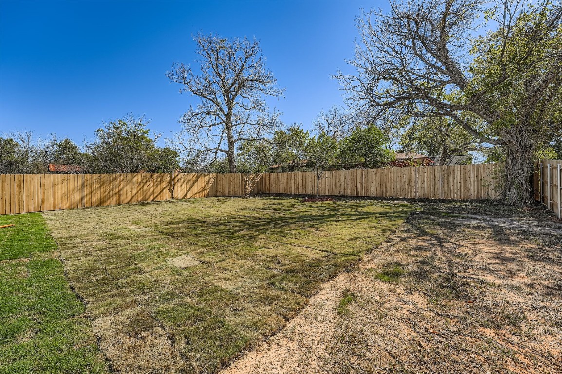 701 East 3rd Street Elgin, TX 78621 - Photo 26 of 28 Spacious fenced backyard with plenty of open green space, perfect for outdoor activities and entertaining