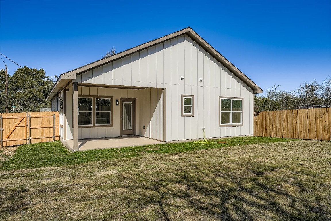 701 East 3rd Street Elgin, TX 78621 - Photo 28 of 28 Beautiful backyard view showcasing a covered patio and a fully fenced yard