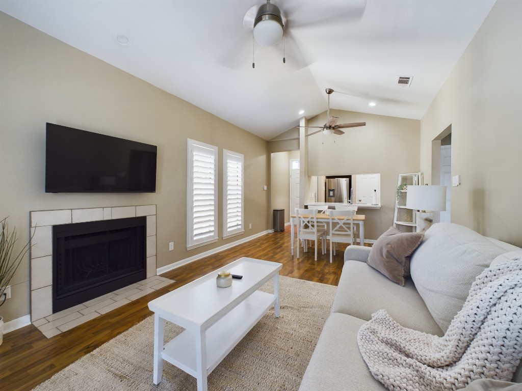 a living room with furniture a fireplace and a flat screen tv