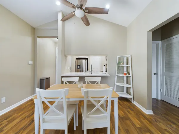 a view of a dining room with furniture and wooden floor