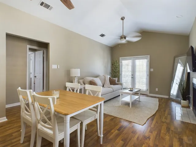 a view of a dining room with furniture wooden floor and a chandelier