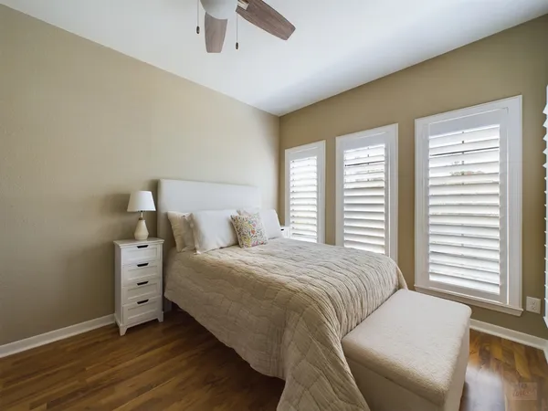 a bedroom with a bed and a large window