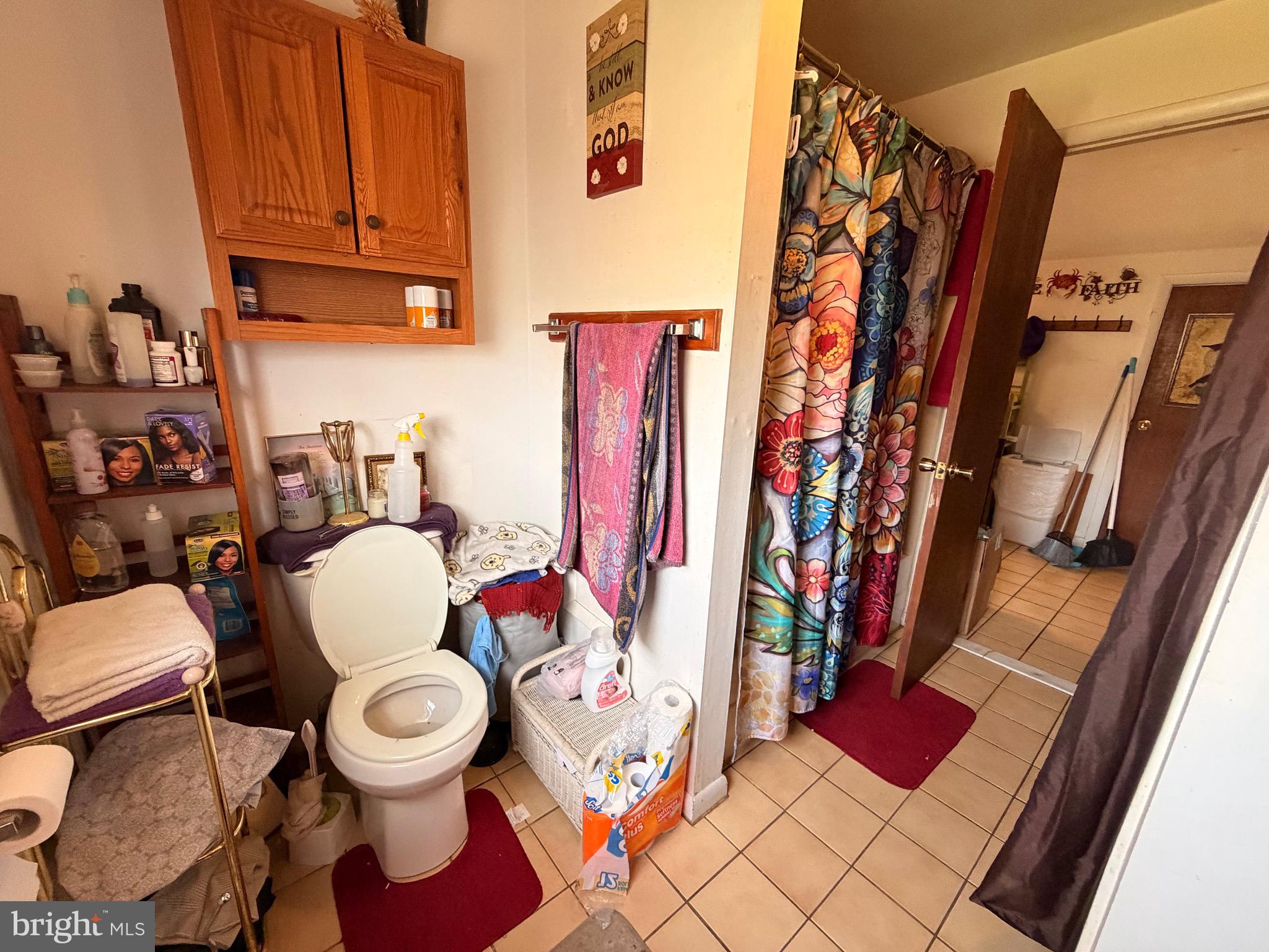 5 West Chestnut Street Delmar, MD 21875 - Photo 22 of 28 a white toilet sitting next to a bathroom sink and a mirror