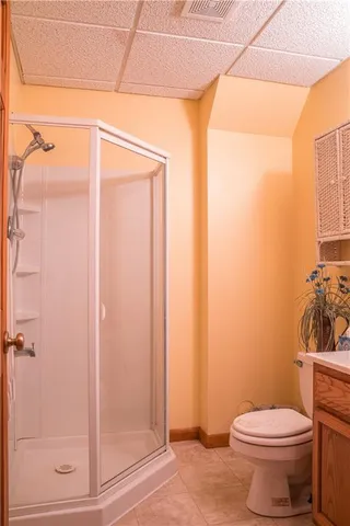 a bathroom with a toilet and shower