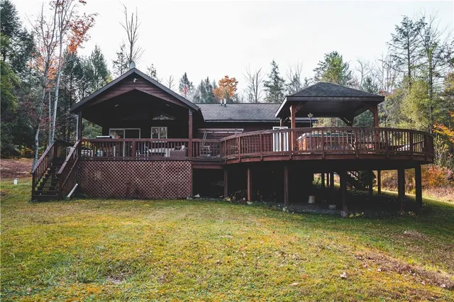 a view of a house with a backyard and a table