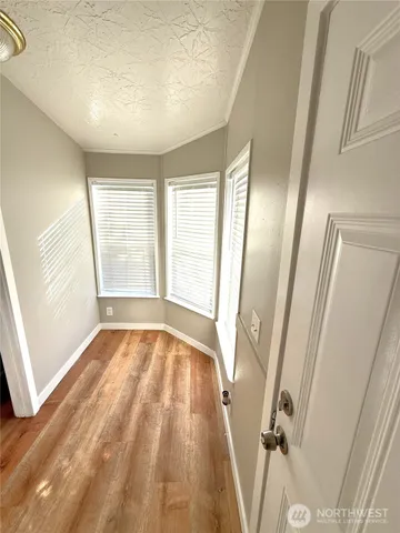 a view of an empty room and wooden floor