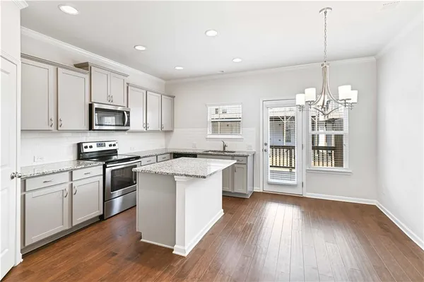 a kitchen with a sink stove and cabinets