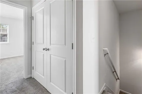 an empty room with a window and a hallway