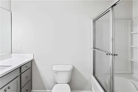 a bathroom with a glass shower door