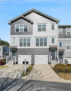 a front view of a house with yard and windows