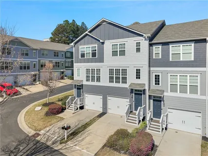 a view of a house with pool and chairs