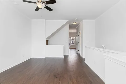 a view of a room with wooden floor and white walls