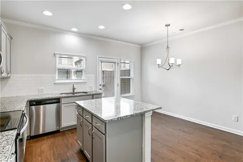 a kitchen with sink cabinets and wooden floor