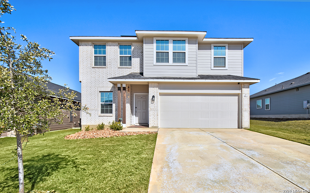a front view of a house with a yard
