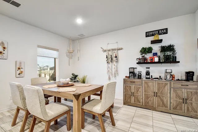 a dining room with furniture and window