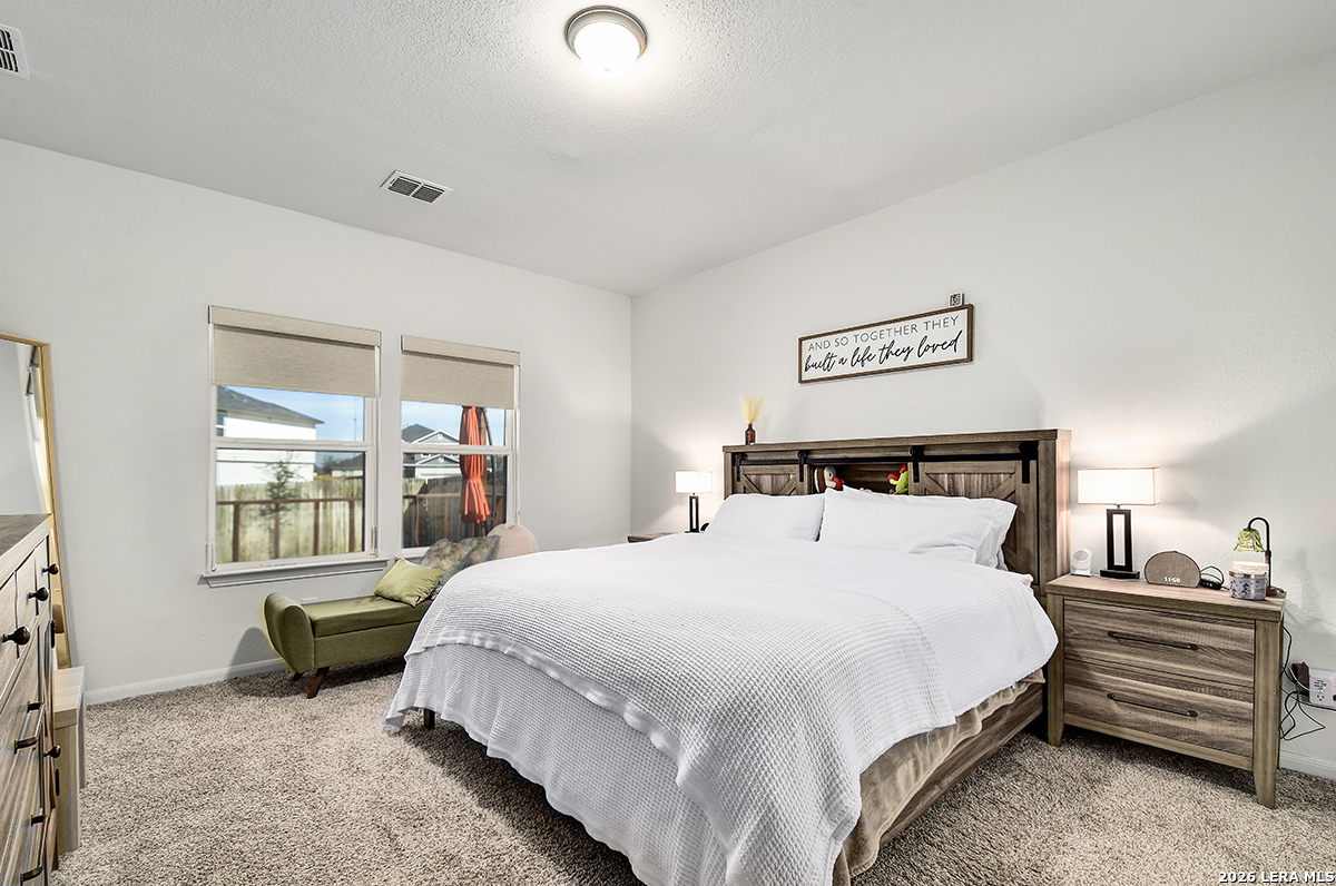 8863 Grey Elm Elmendorf, TX 78112 - Photo 19 of 35 a bedroom with bed and window