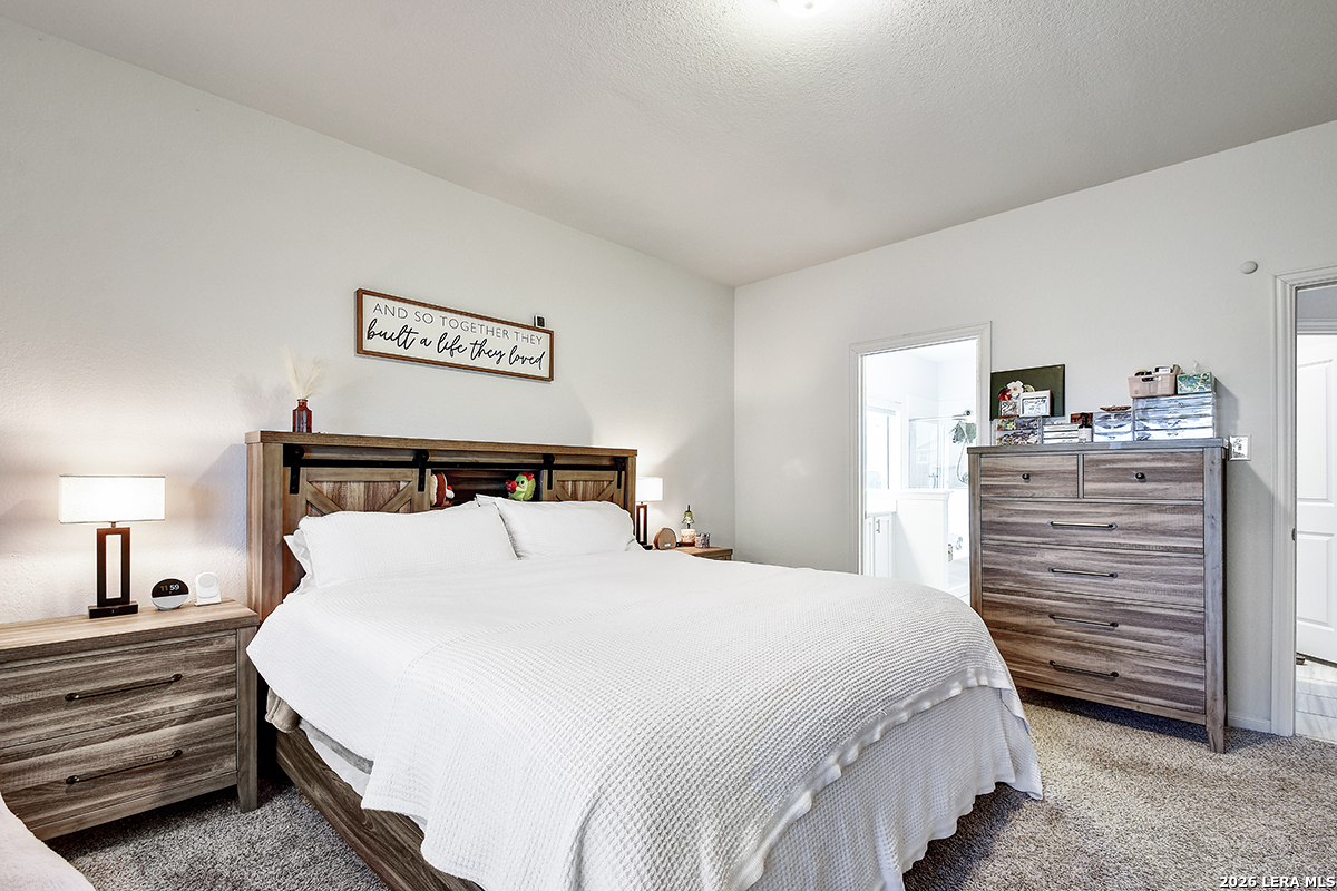 8863 Grey Elm Elmendorf, TX 78112 - Photo 20 of 35 a bedroom with a bed and a dresser