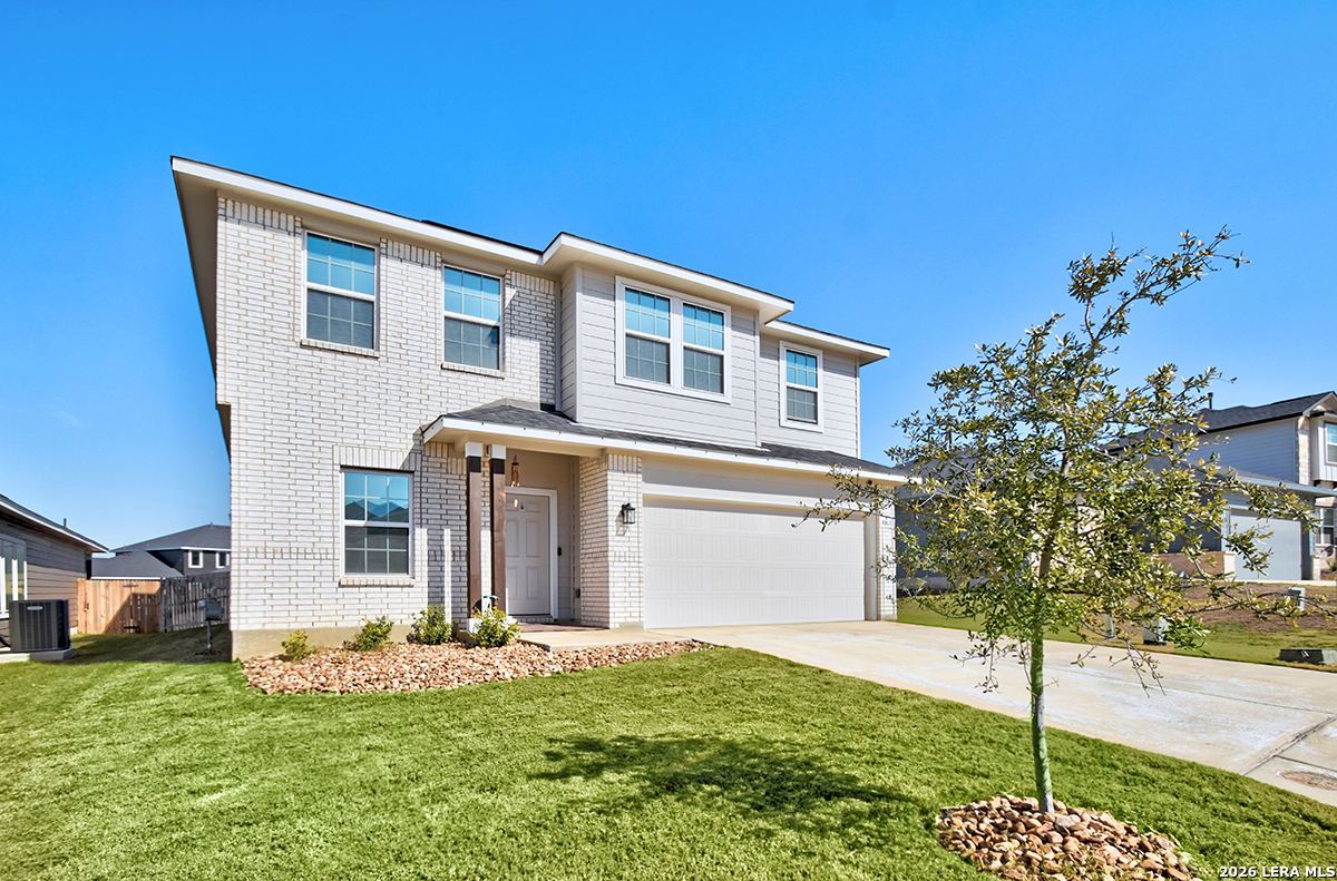 8863 Grey Elm Elmendorf, TX 78112 - Photo 2 of 35 a front view of a house with a yard