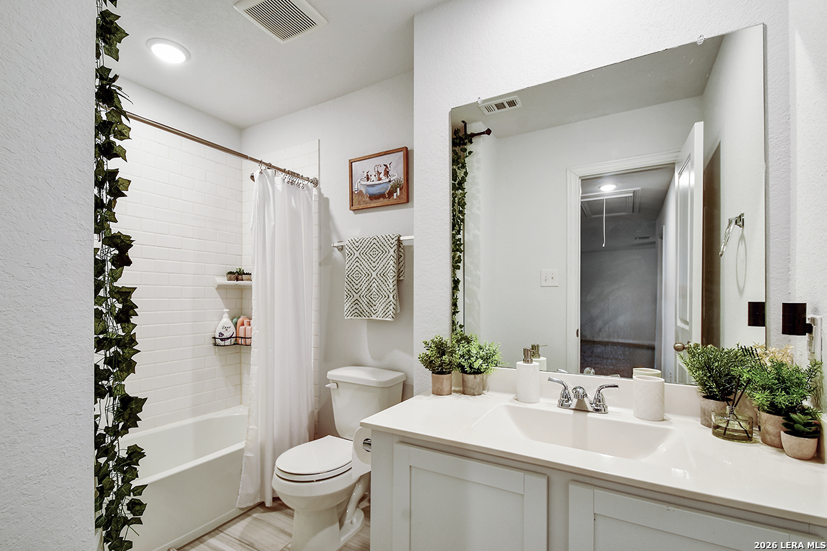 8863 Grey Elm Elmendorf, TX 78112 - Photo 29 of 35 a bathroom with a sink toilet and shower