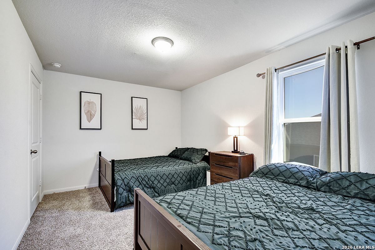 8863 Grey Elm Elmendorf, TX 78112 - Photo 30 of 35 a bedroom with bed and window