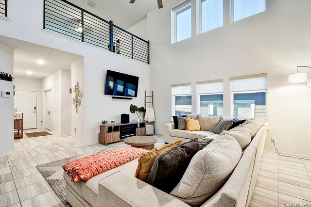 a living room with furniture a flat screen tv and a fireplace