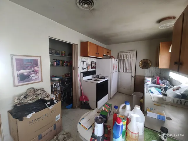 a kitchen with stainless steel appliances kitchen island granite countertop a stove and a refrigerator