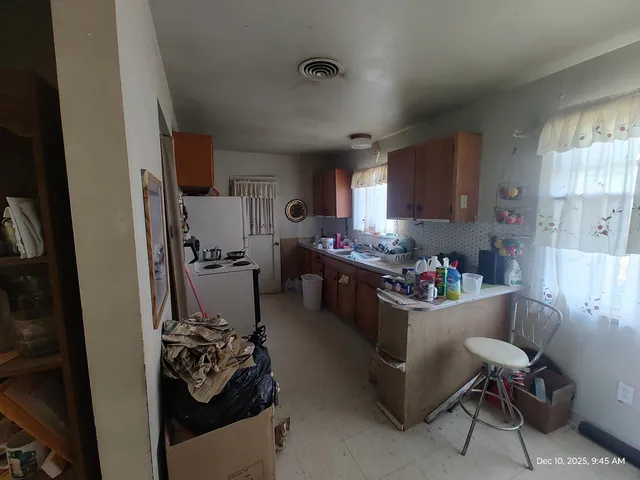 a room with furniture and a view of kitchen