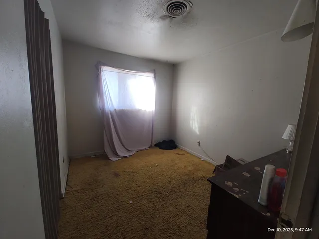 a view of an empty room and window