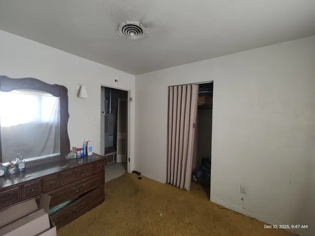 a room with two mirror and a dresser