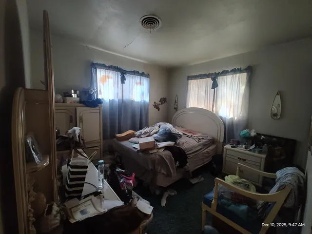 a bedroom with furniture and a window