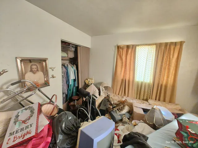 a bedroom with furniture and a window