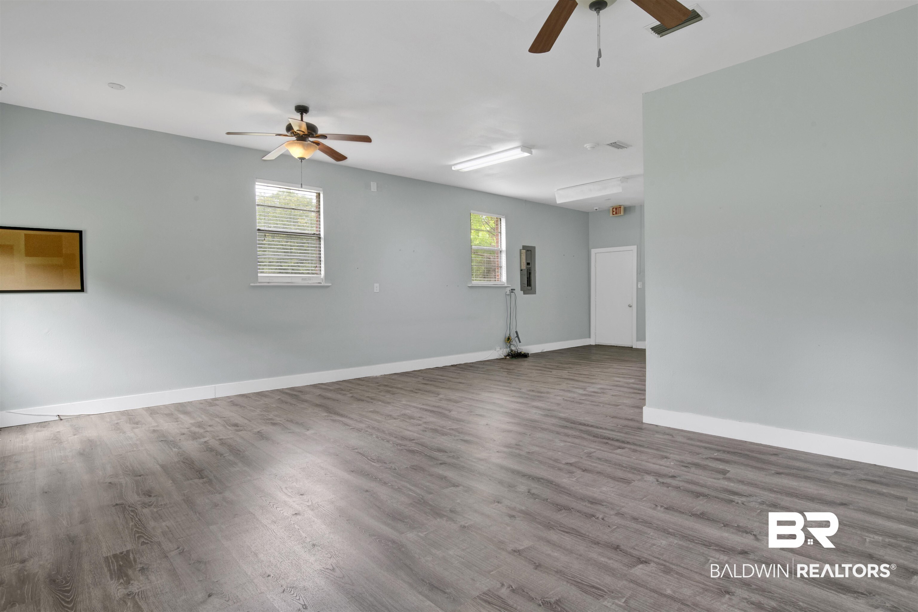 17714 Horseneck Road Bay Minette, AL 36507 - Photo 10 of 36 Spacious interior featuring wood-finish flooring, light grey walls, and multiple windows