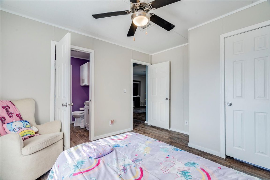 114 Gran Cielo Elgin, TX 78621 - Photo 15 of 40 a bedroom with a bed and a chandelier